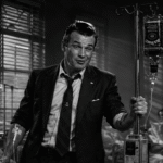 A drunken Whiskey Pete Hegseth visiting wounded Service members in Military hospital. Pete Hegseth has an IV in his arm and is pushing a mobile intravenous infusion pole. The IV bag is an upside bottle of whiskey. 1940's Noir style. Black and white