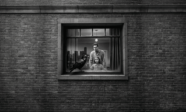A jet black raven perches on a windowsill in front of a man and little girl. Noir